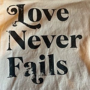 ‘Love Never Fails’ distressed tee